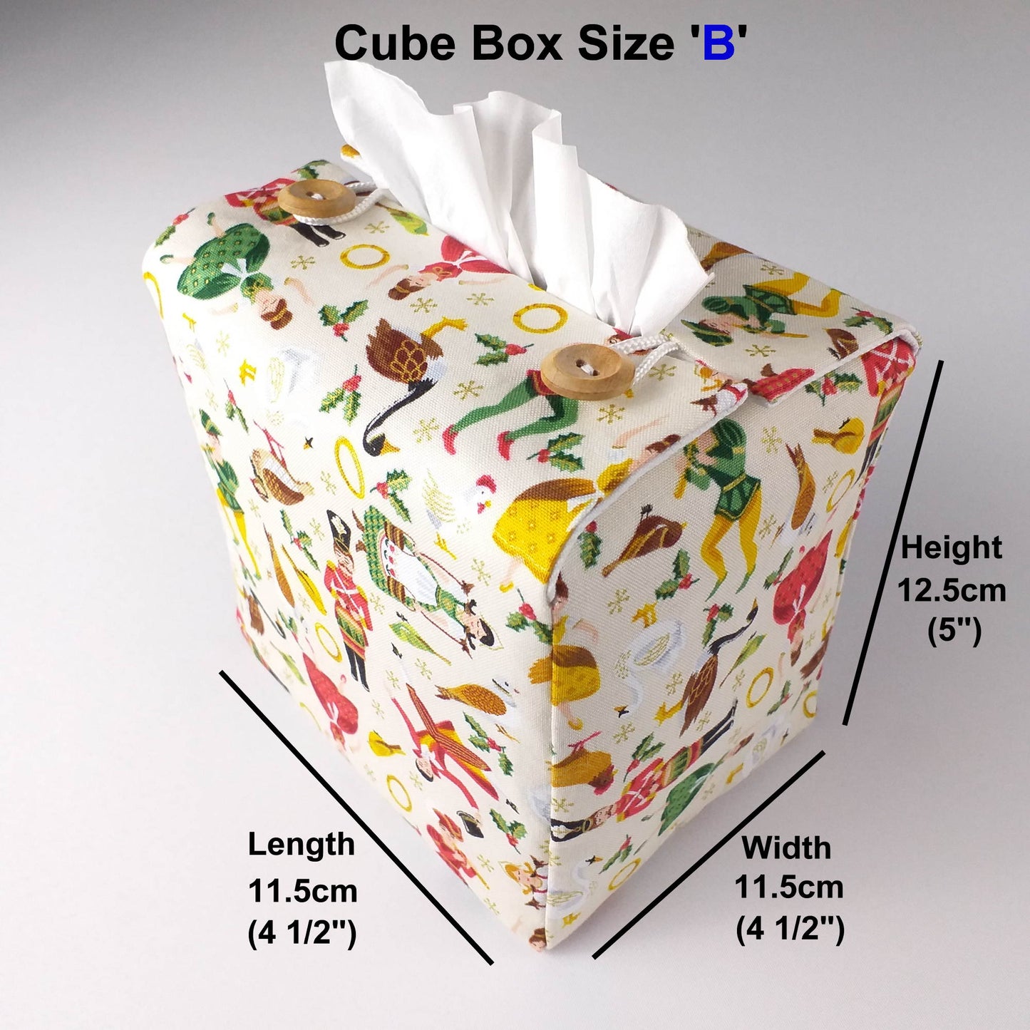 Square tissue box cover with holiday themed icons of the Twelve Days of Christmas on cream background