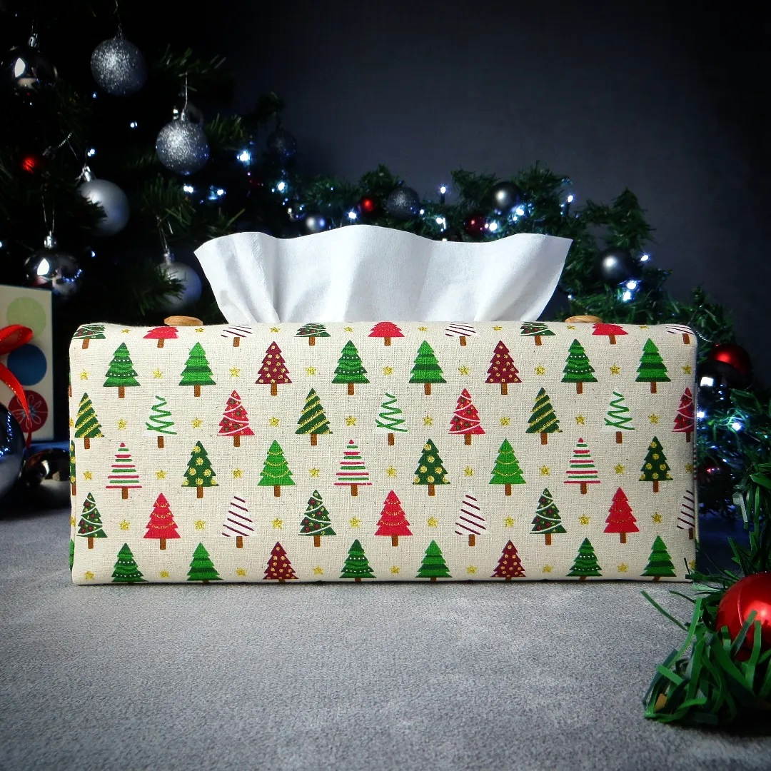 Rectangular tissue box cover with holiday themed multi colour decorated Christmas trees design on beige background