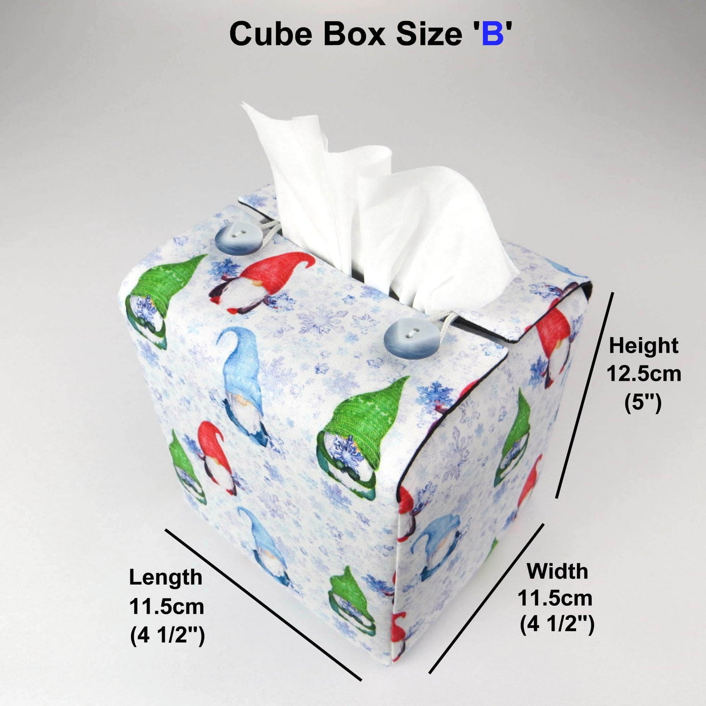 Square tissue box cover with holiday themed red, green, and blue gnomes design on white and blue snowflake pattern background