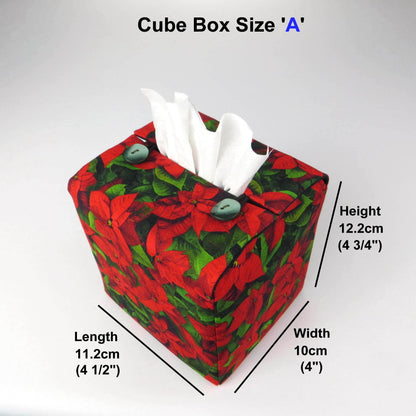 Square tissue box cover with holiday themed poinsettia design on green leaf pattern background