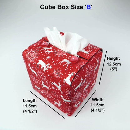 Square tissue box cover with holiday themed white reindeer design on red background