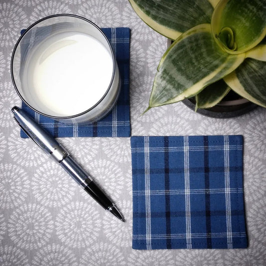 Square coasters with black, white, and blue plaid pattern
